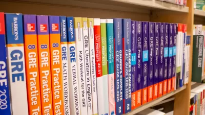 A row of GRE exam study books lined up neatly in a bookstore.