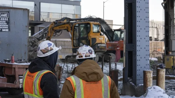 Workers in hard hats looking at Gateway Tunnel construction work.