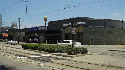 Greyhound bus station in Houston, Texas next to street with light rail tracks.