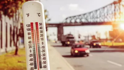 Thermometer infront of blurred image of street during heat wave