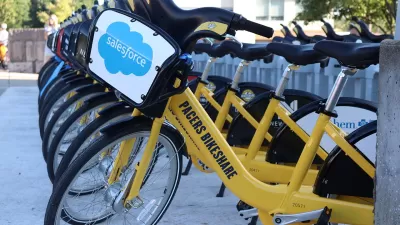 Row of yellow Pacers Bikeshare bikes at station in downtown Indianapolis, Indiana.