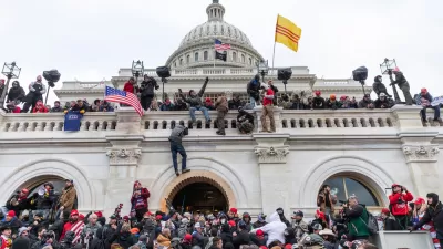 Trump supporting insurrectionists scale the walls of the U.S. Capitol Building on January 6, 2021.