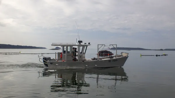 White small fishing boat on water.