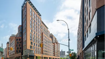 A conceptual rendering of a high-rise apartment building in an urban area.