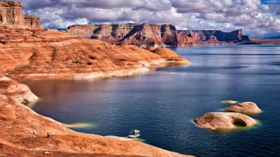 Rock formation along Lake Powell with hosueboat