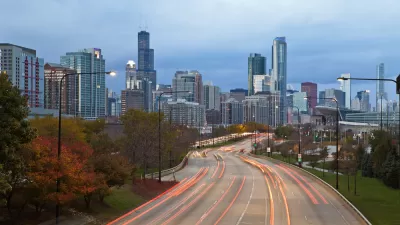 A blur of car taillights illuminate Lake Shore Drive approaching Downtown Chicago.