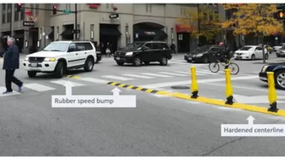 Crosswalk in Chicago with newly installed yellow delineators and speed bumps