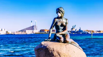 A statue of the Little Mermaid, overlooking the waterfront of Copenhagen, Denmark, is adorned with a mask during the Covid-19 pandemic.