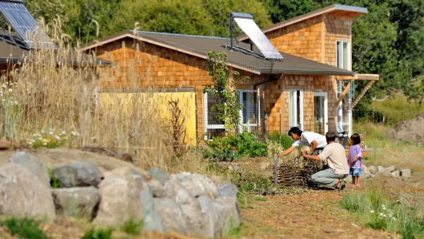 A family gardening in front of a house