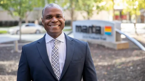 Former MARTA CEO Collie Greenwood standing in front of MARTA HQ with blurred MARTA sign visible in background.