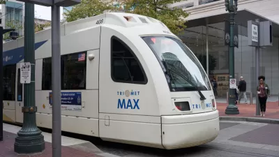 A TriMet MAX Red Line light rail train heading for the Portland International Airport comes to a stop at Pioneer Place in downtown Portland.