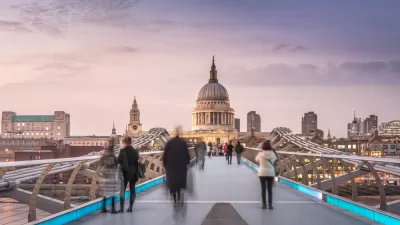 An image of pedestrians walking across the Millennium Bridge toward St. Paul's cathedral in London.