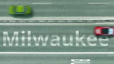 A blurred image shows two cars driving on a road labeled with the word Milwaukee.