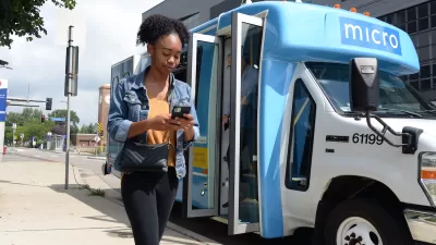 Girl walking in front og blue and white minibus with 'micro' logo in Minneapolis, Minnesota.