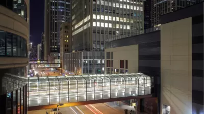 A series of pedestrian bridges, linking buildings on either side of the street, are illuminated int he night in downtown Minneapolis.