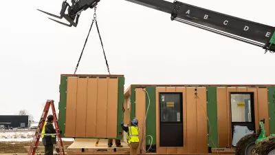 Modular housing being installed with crane.