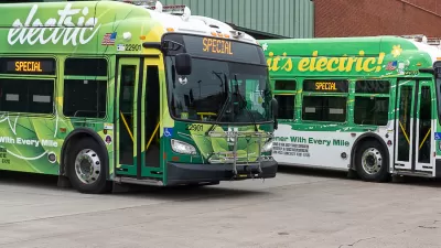 Parked green electric NJ Transit buses.