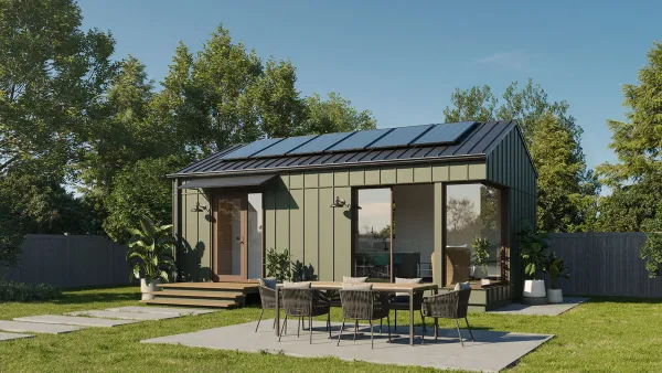 Rendering of green backyard cottage in a grassy yard.