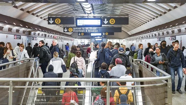 Crowded stairwell in New York City subway station.