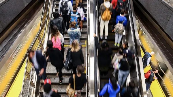 Blurred crowd on New York City subway escalator.