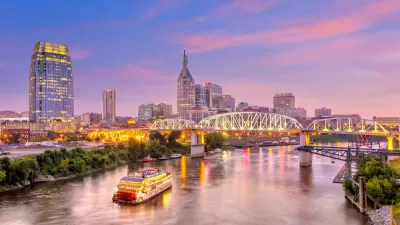 An image of Downtown Nashville with the Cumberland River at dusk.