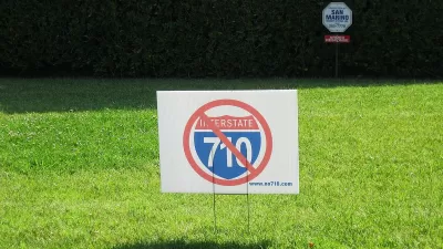 "No 710" lawn sign on green lawn.