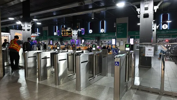 Silver fare collection gates at MBTA subway station.