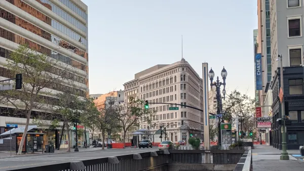 Street in Oakland, California with subway entrance in foreground.