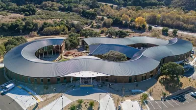 Aerial view of Ohana mental health facility in Monterey, California with wavy silver roof.