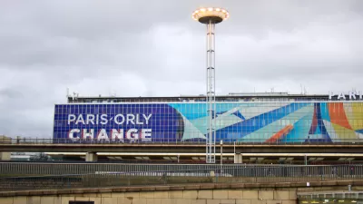 The exterior of a terminal at Orly Airport in France, with a large graphic that reads “Orly Change.”