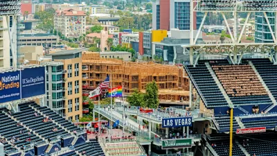 An image of stadium seats at Petco Park in San Diego, with new buildings under construction nearby in the background.