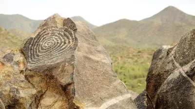 A spiral petroglyph adorns a rock in the desert of Arizona.