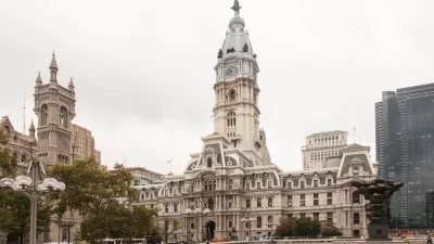 An empty pedestrian plaza is shown in front of Philadelphia City Hall.