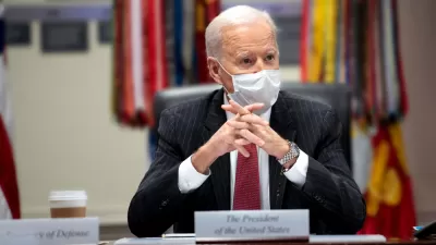 An image of President Joe Biden at a meeting in the White House while wearing a mask in February 2021.