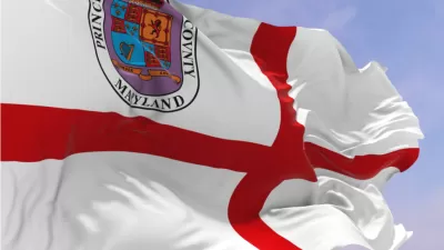 The flag of Prince George's County00a red croiss in a white field with a crest of arms in the upper left corner, blows in the wind.