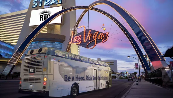 A zero-emission hydrogen fuel-cell bus under a Las Vegas sign.