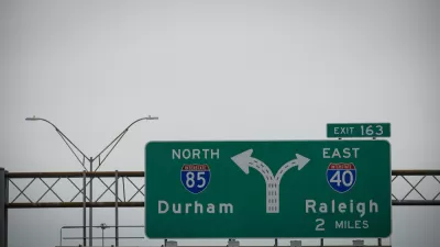 A freeway sign for an intersection showing Interstate 85 for Durham on the left and Interstate 40 for Raleigh on the right.