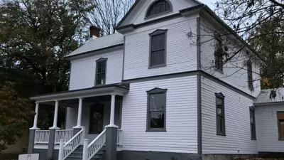 Restored white two-story historic home with black trim in Roanoke, Virginia