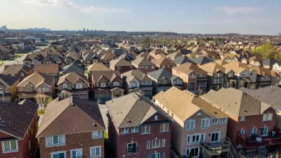 Row after row after row of single-family residences, with the high rises of the city of Toronto looming far in the background.