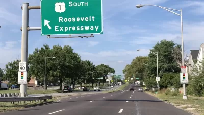 View of three-lane Roosevelt Boulevard with green Roosevelt Expressway road sign in Philadelphia, Pennsylvania.