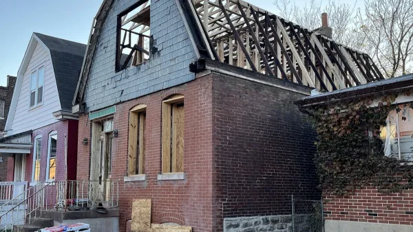 Brick two-story home with barn-shape roof under construction in St. Louis, Missouri.