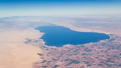 The land locked Salton Sea, seen from the air, is surrounded by mountains, desert, and farm land.
