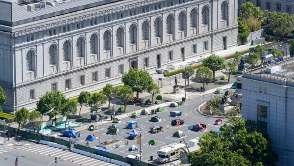 A group of socially distanced tents for the homeless are set up on a parking lot in San Francisco's Civic Center.