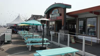 The former parking of Woodies restaurant is filled with empty picnic tables for dining during the Covid-19 pandemic.