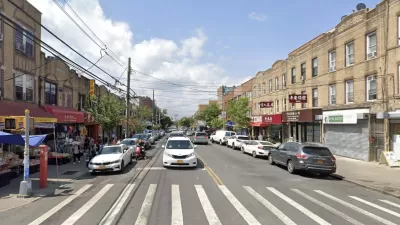 Google Street View of 8th Avenue in Brooklyn with crosswalk in foreground, cars, and brick three-story buildings
