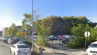 Google street view of vacant lot used for parking and surrounded by chain link fence and shrubbery in East New York
