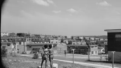 Black and white photo of two young boys standing on a hill overlooking the Frederick Douglass housing project in Anacostia, D.C.