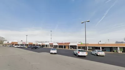 Google Maps view of one-story shopping center with large parking lot.