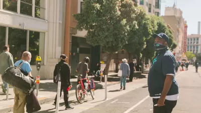 People walking and biking on protected bike lane in Tenderloin District, San Francisco.
