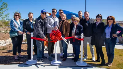 Officials cutting a ceremonial red ribbon at Skyline Ranch Park in Santa Clarita, California.